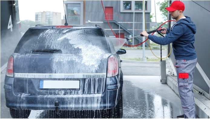 A Worker is washing a Car